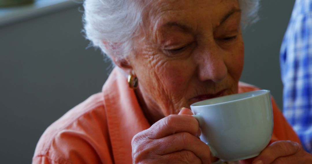 Elderly Woman Drinking Tea in Comforting Home Environment - Free Images, Stock Photos and Pictures on Pikwizard.com