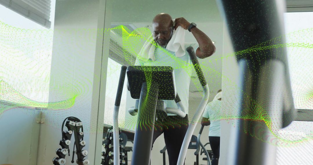 Senior Man Exercising with Towel on Treadmill in Gym