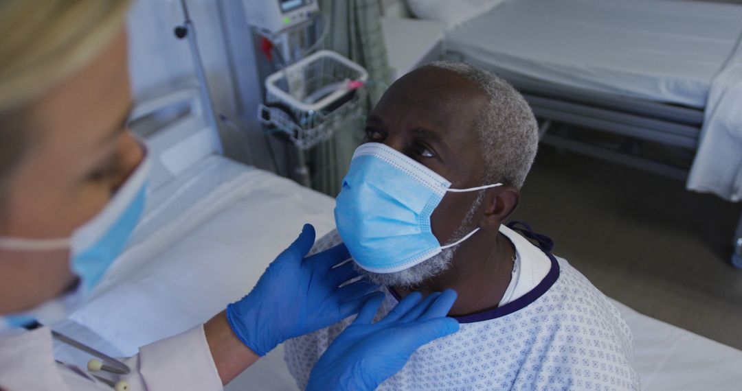 Healthcare Worker Treating Senior Patient in Hospital with Mask - Free Images, Stock Photos and Pictures on Pikwizard.com