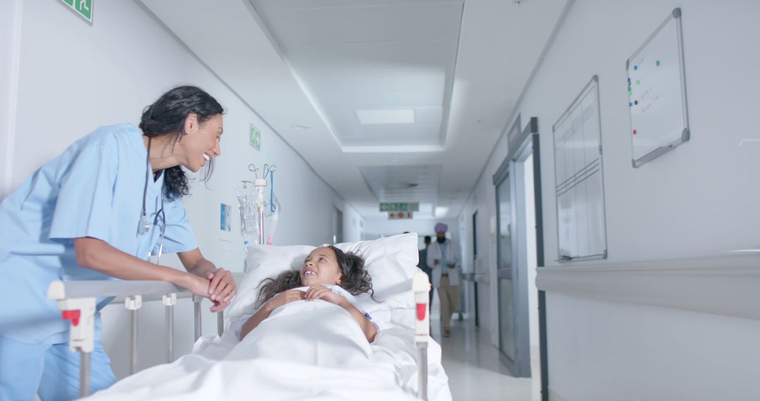 Nurse Comforting Child Patient On Hospital Bed In Corridor - Free Images, Stock Photos and Pictures on Pikwizard.com