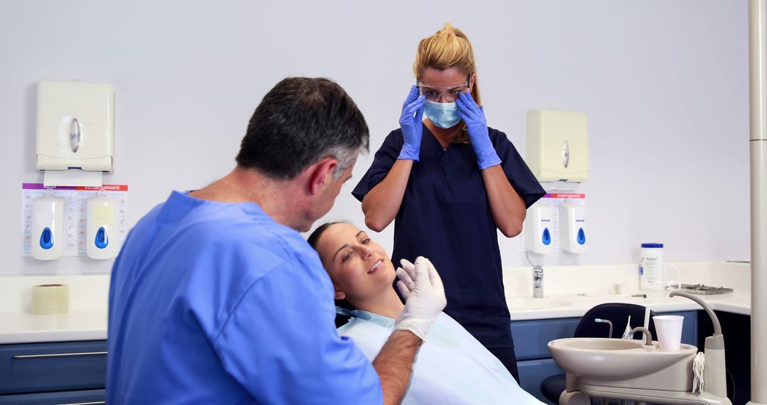 Patient in Dental Chair Receiving Treatment from Dentist and Assistant - Free Images, Stock Photos and Pictures on Pikwizard.com