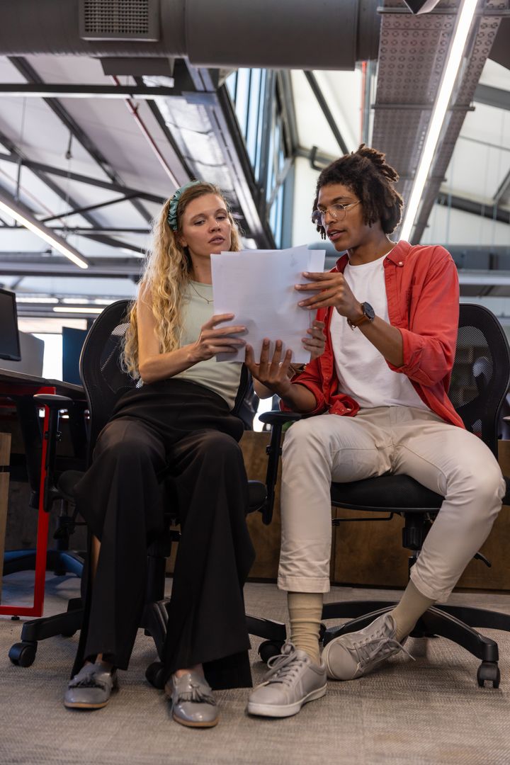 Diverse Coworkers Engaging in Productive Office Collaboration