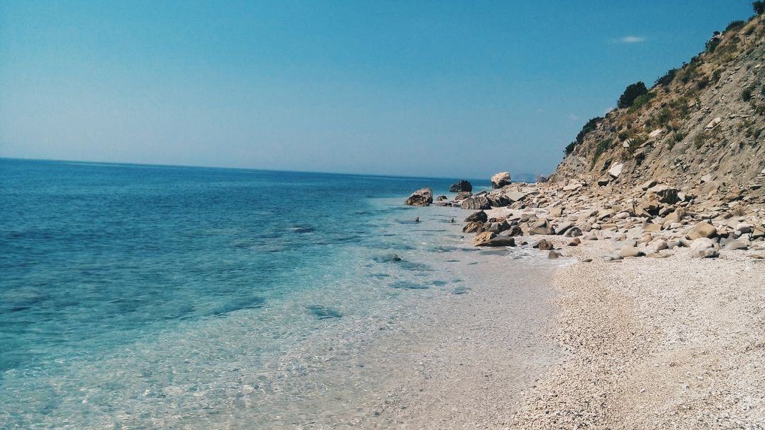 Scenic View of Rocky Coastline with Clear Blue Water - Free Images, Stock Photos and Pictures on Pikwizard.com