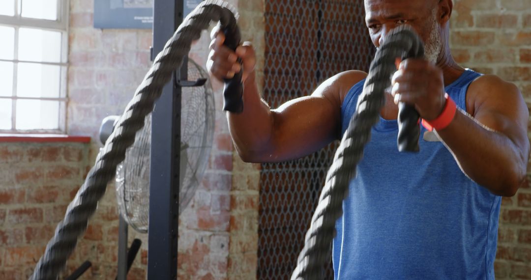 Senior Man Exercising With Battle Ropes in Gym - Free Images, Stock Photos and Pictures on Pikwizard.com