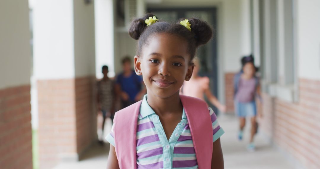 Image of happy african american girl standing at school corridor - Free Images, Stock Photos and Pictures on Pikwizard.com