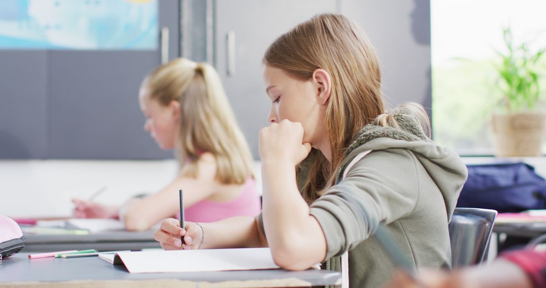 Diverse Students Focused on Class Writing Assignment