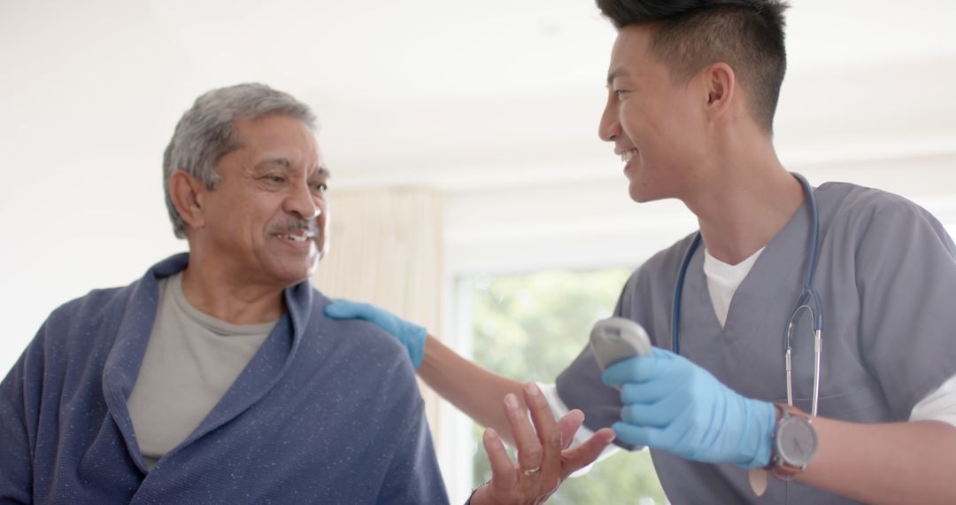 Young Nurse Assisting Elderly Man Using Digital Thermometer at Home - Free Images, Stock Photos and Pictures on Pikwizard.com