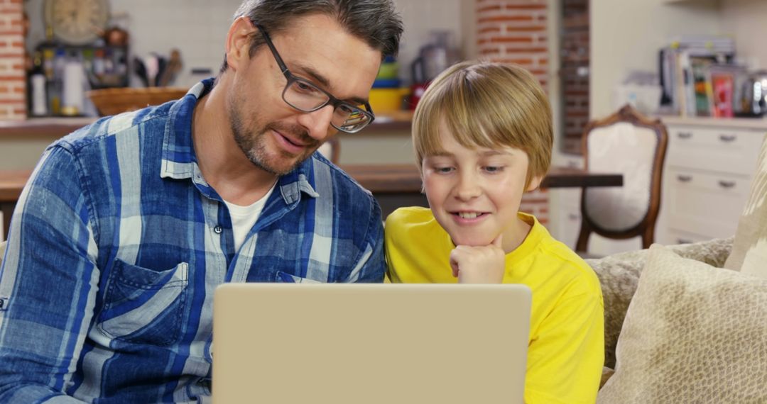 Father and Son Using Laptop at Home - Free Images, Stock Photos and Pictures on Pikwizard.com