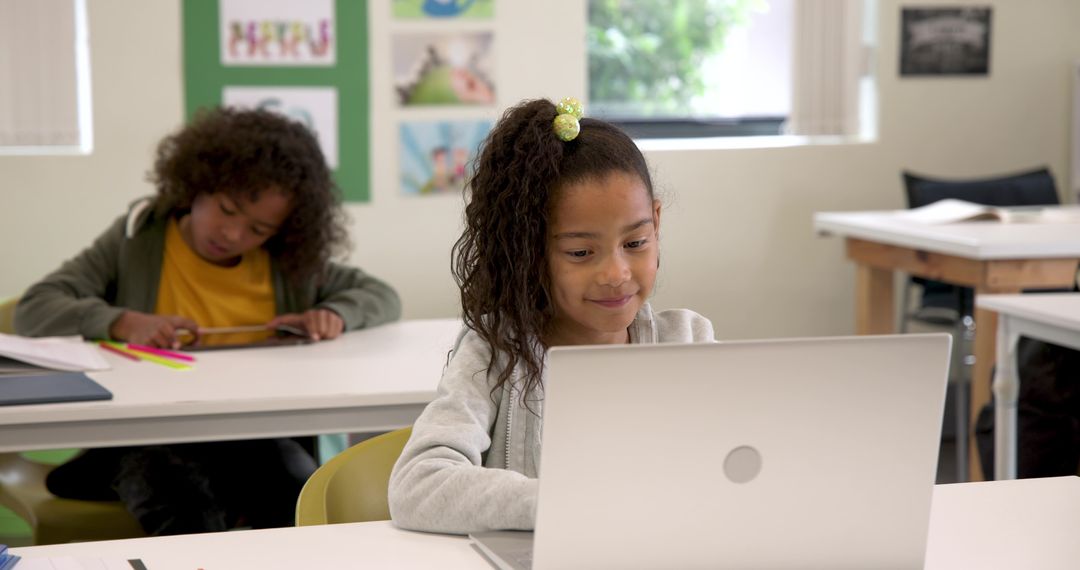Students in Classroom Using Laptop and Tablet for Learning