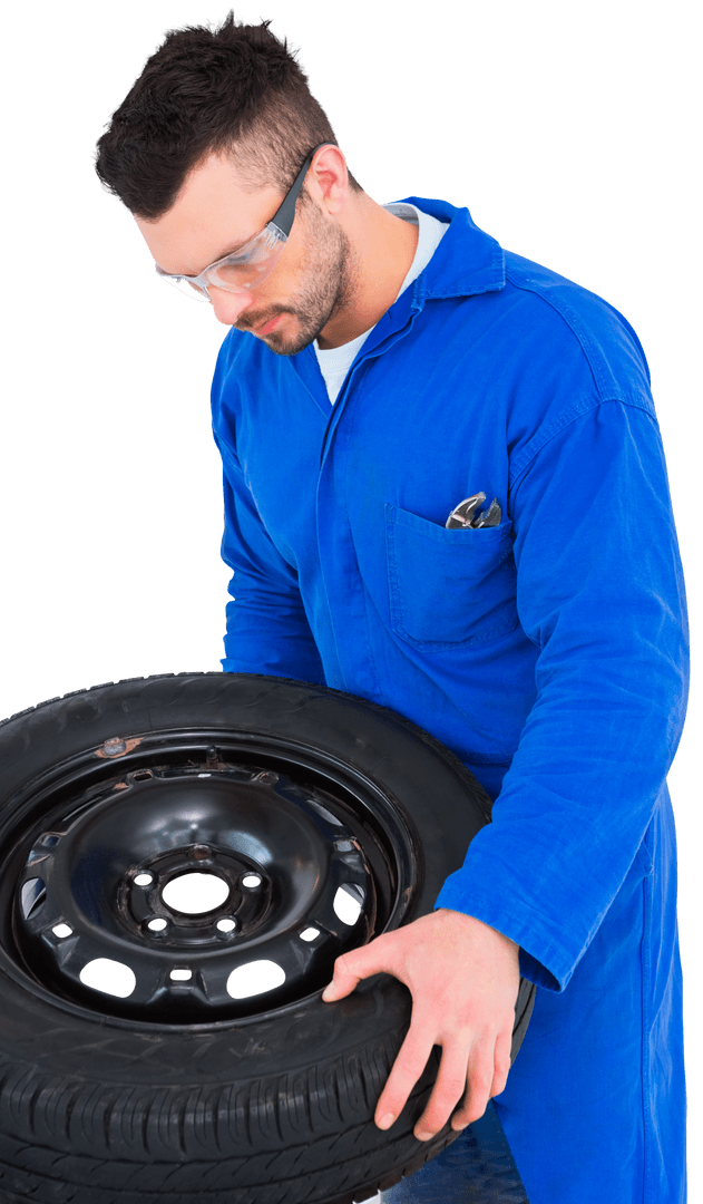 Mechanic in Blue Overall Working on Car Tire Transparent
