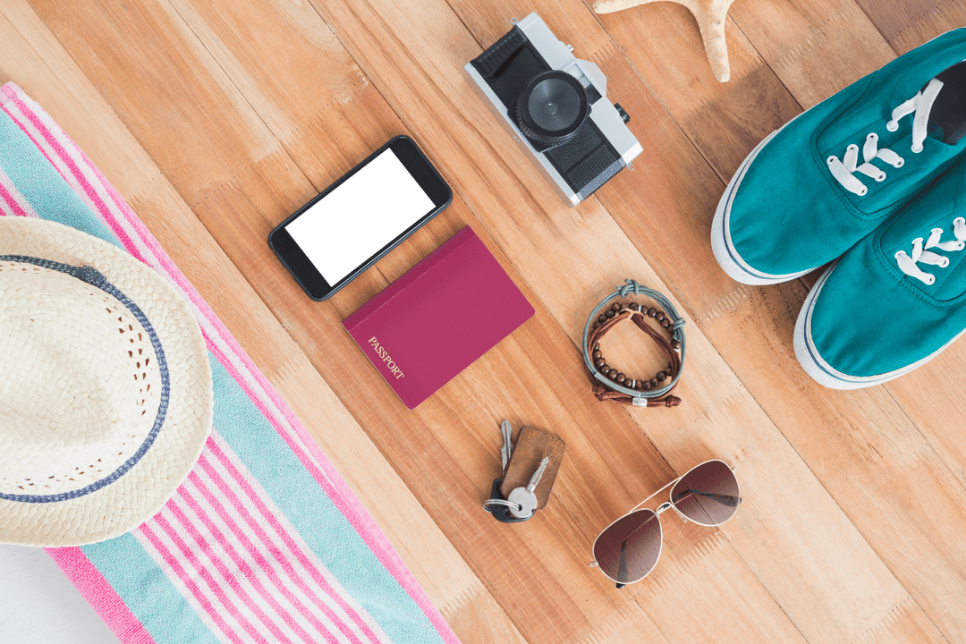 Travel Essentials Flat Lay on Transparent Wooden Surface