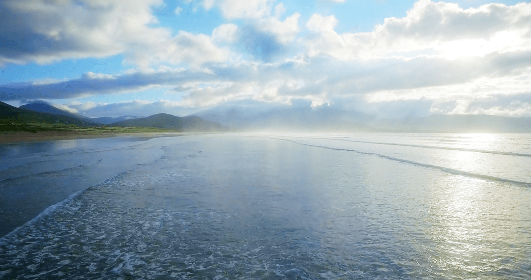 Stunning Transparent Waves Under Pristine Cloudy Sky