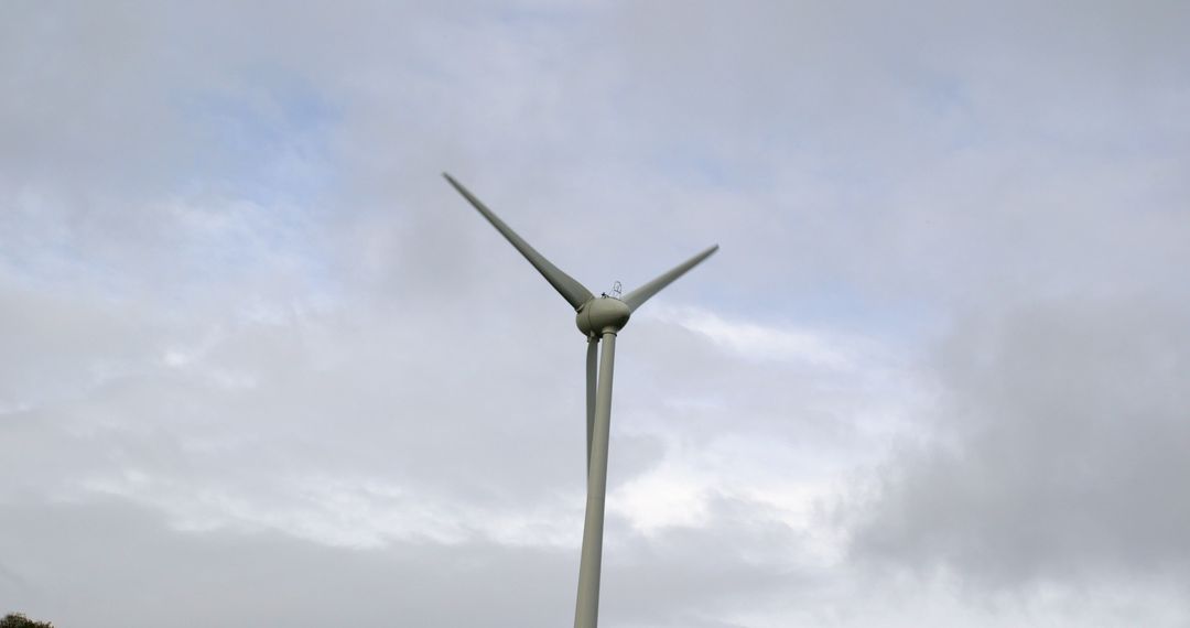 Modern Wind Turbine against Cloudy Sky for Renewable Energy - Free Images, Stock Photos and Pictures on Pikwizard.com