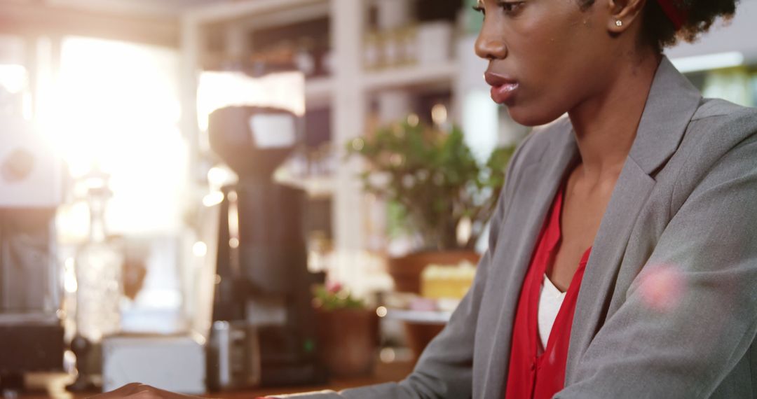 Professional woman engaged in work on laptop in cafe
