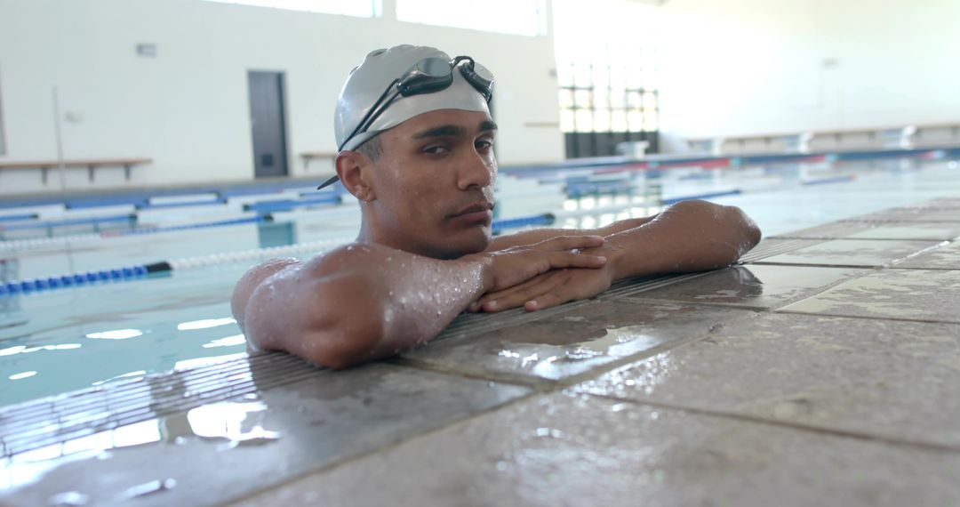 Competitive Swimmer Resting at Pool Edge with Goggles and Silver Swim Cap