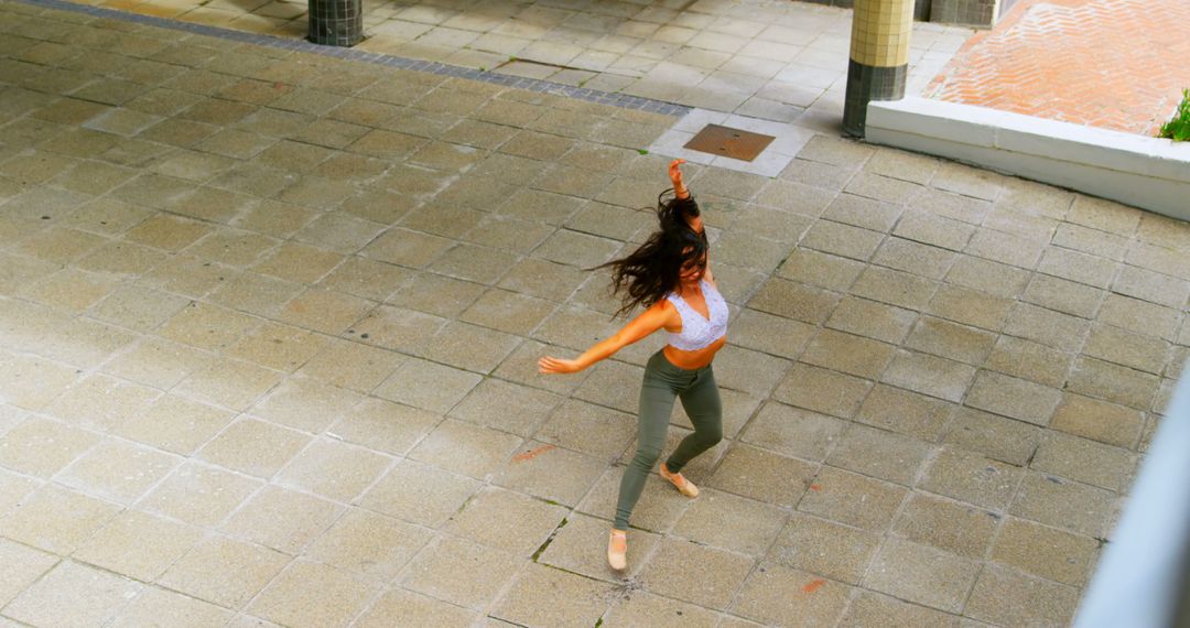 Woman Dancing Outdoors on Pavement in Daylight - Free Images, Stock Photos and Pictures on Pikwizard.com