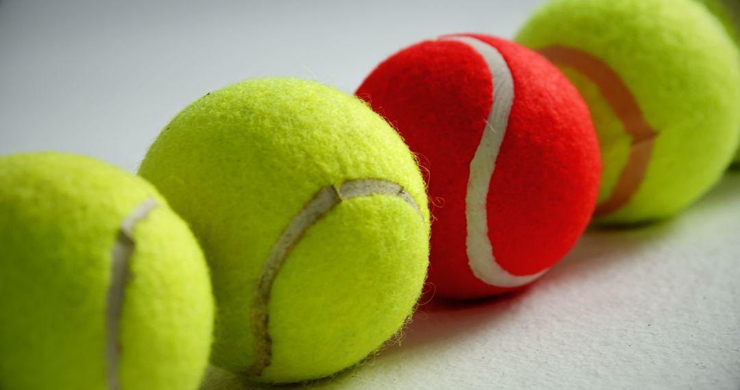 Close-Up of Tennis Balls Positioned in Line on White Surface - Free Images, Stock Photos and Pictures on Pikwizard.com