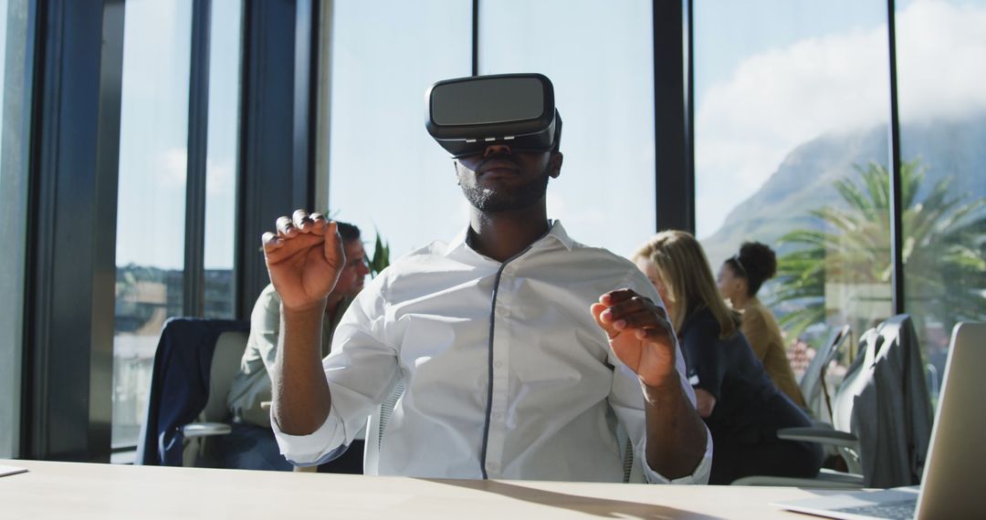 Businessman using virtual reality headset at office workspace - Free Images, Stock Photos and Pictures on Pikwizard.com