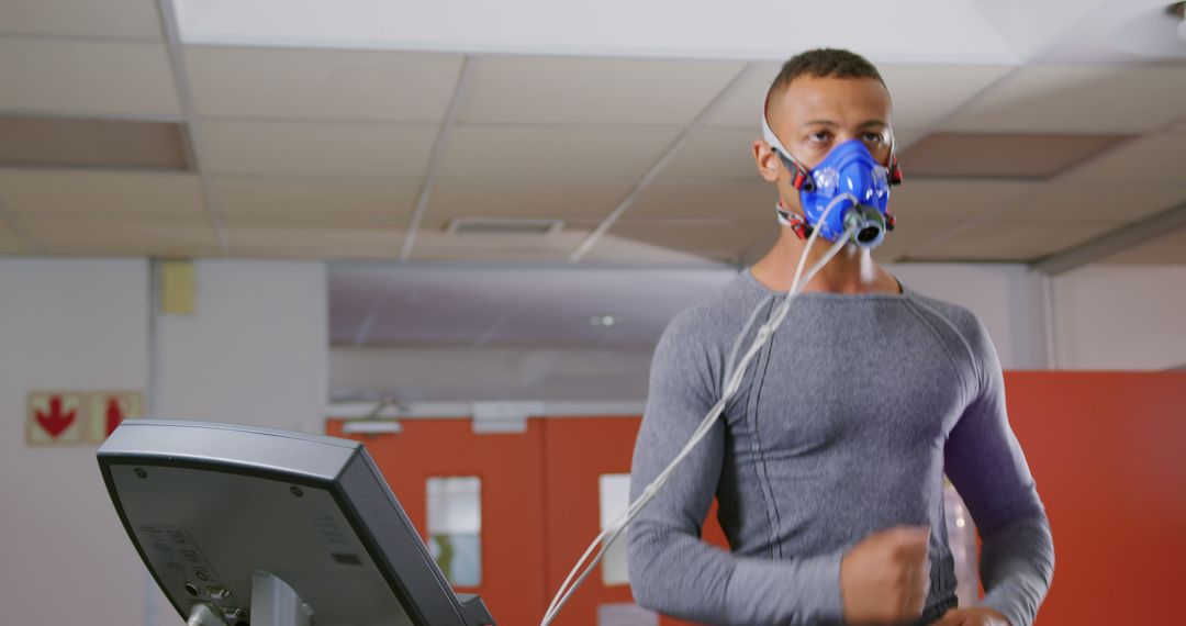 Man Undergoing Fitness Test Wearing Respiratory Mask on Treadmill - Free Images, Stock Photos and Pictures on Pikwizard.com