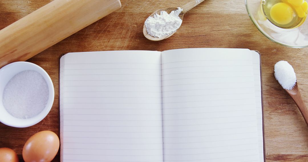 Blank Recipe Book with Baking Ingredients on Wooden Surface