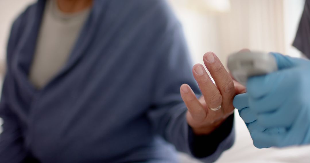 Elderly man receiving healthcare assistance with pulse oximeter - Free Images, Stock Photos and Pictures on Pikwizard.com