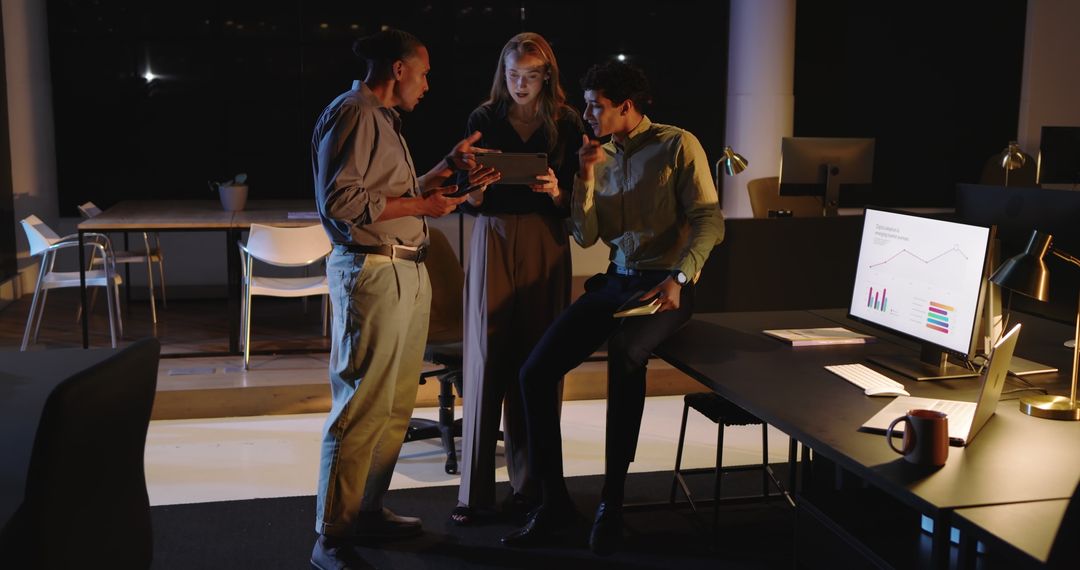 Diverse Business Team Collaborating with Digital Technology at Night