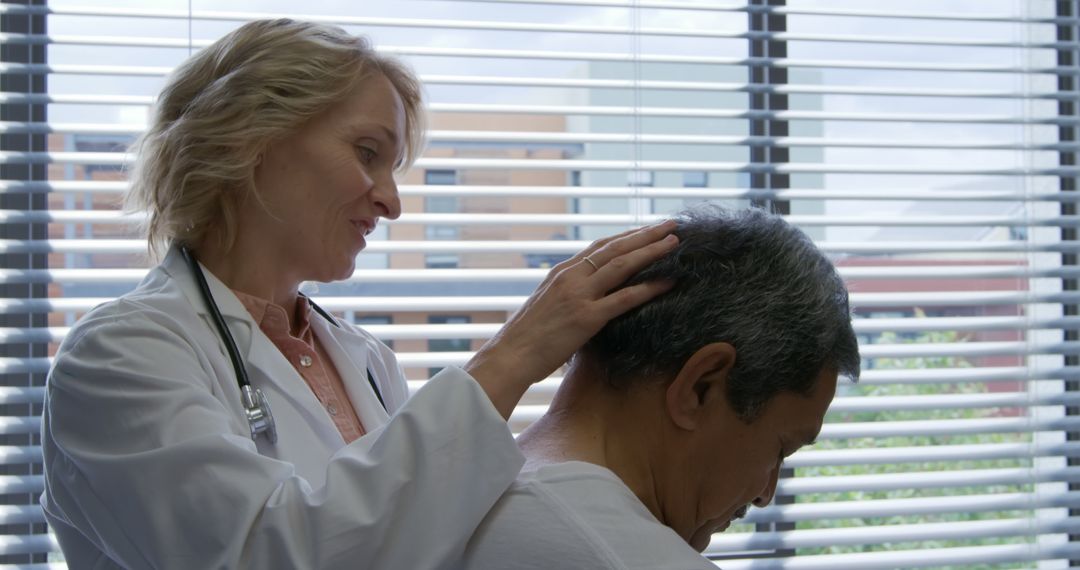 Doctor Examining Patient's Head in Hospital Room - Free Images, Stock Photos and Pictures on Pikwizard.com