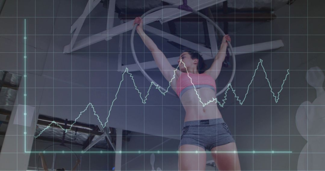 Aerial Fitness Enthusiast Training on Hoop with Graph Overlay