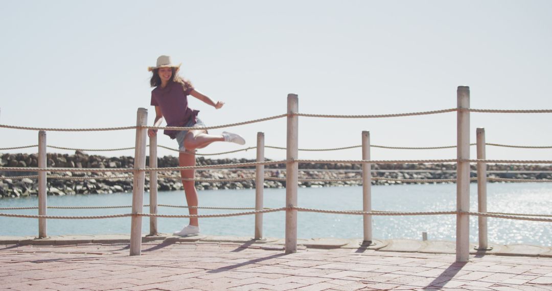 Carefree Woman Enjoying Sunny Day by Oceanside - Free Images, Stock Photos and Pictures on Pikwizard.com