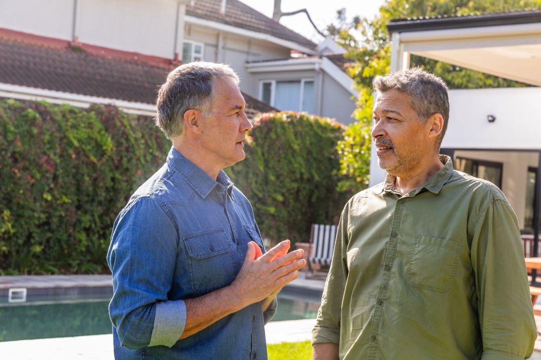 Middle-Aged Friends Chatting by Backyard Pool in Suburban Lifestyle Setting