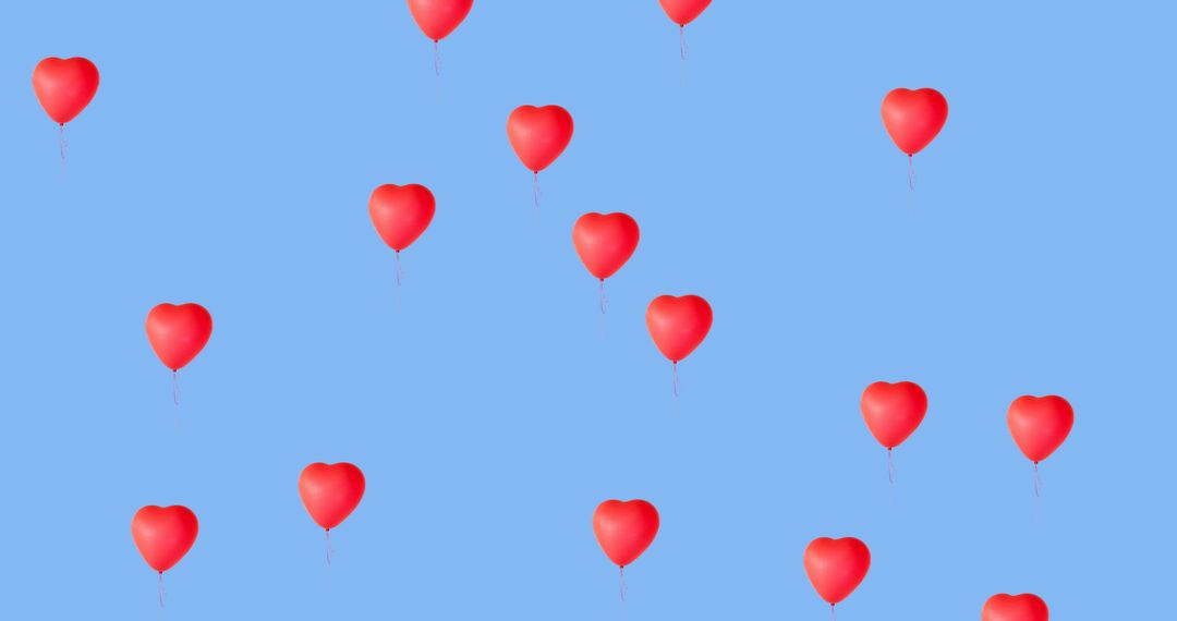Floating Red Heart Balloons on Clear Blue Background