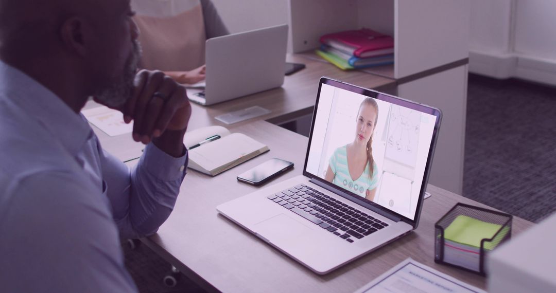 Mature Professional Engaged in Virtual Video Call in Office Workspace