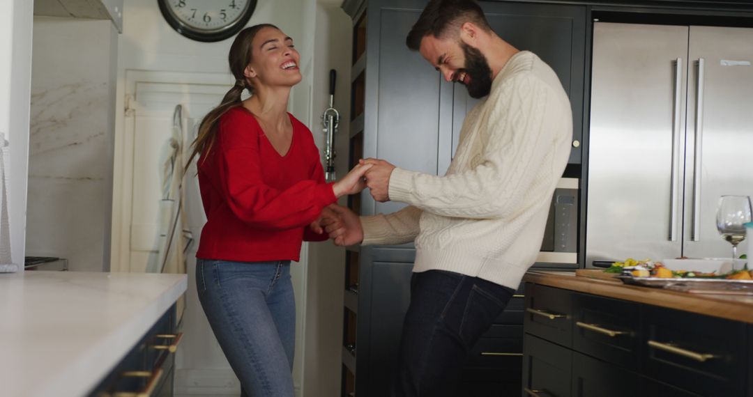 Smiling Couple Dancing Together in Modern Kitchen - Free Images, Stock Photos and Pictures on Pikwizard.com