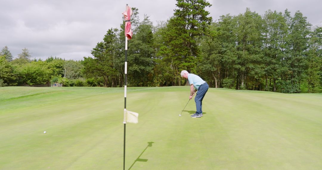 Senior Golfer Practicing on Green Amidst Nature