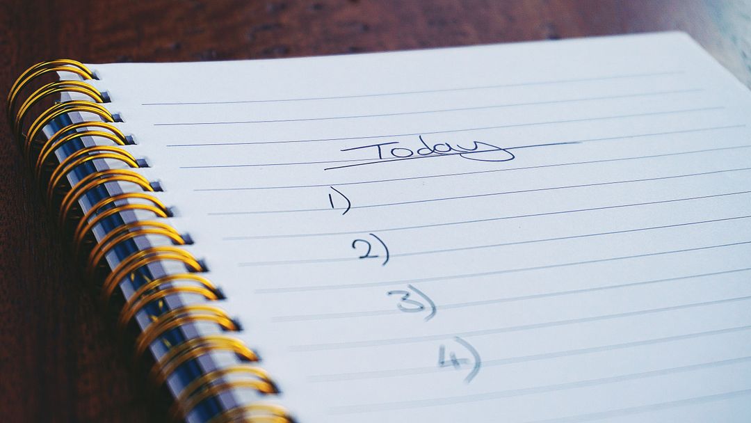 Blank Daily To-Do List in Spiral Notebook on Wooden Desk