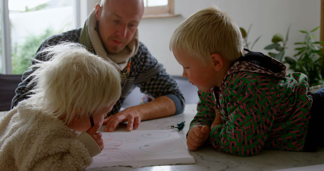 Father Encouraging Young Children's Drawing Skills at Home