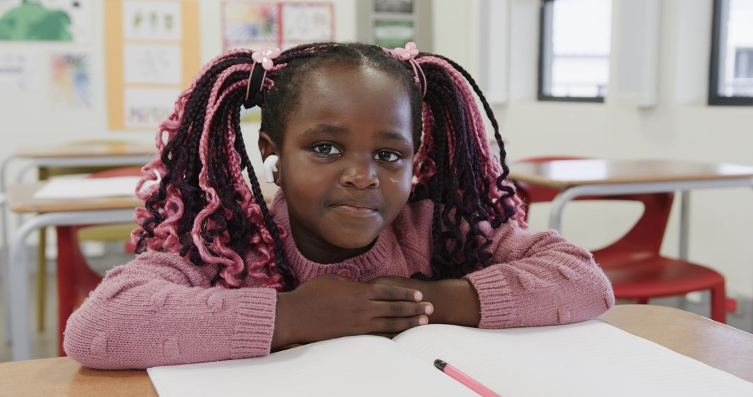 Young Girl in Classroom Focused on Writing and Learning