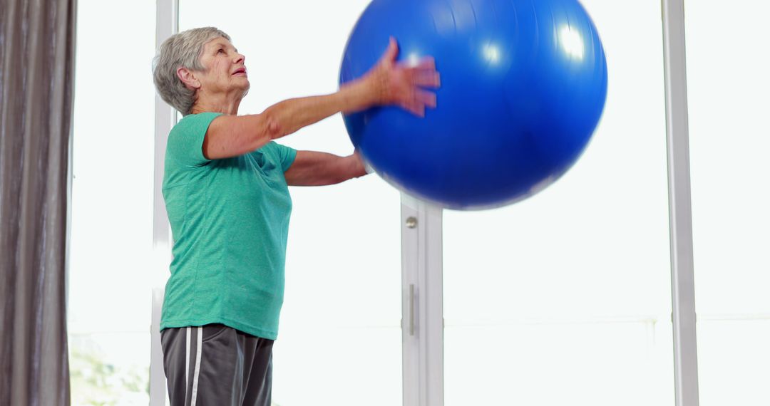 Senior Woman Exercising with Stability Ball at Home - Free Images, Stock Photos and Pictures on Pikwizard.com