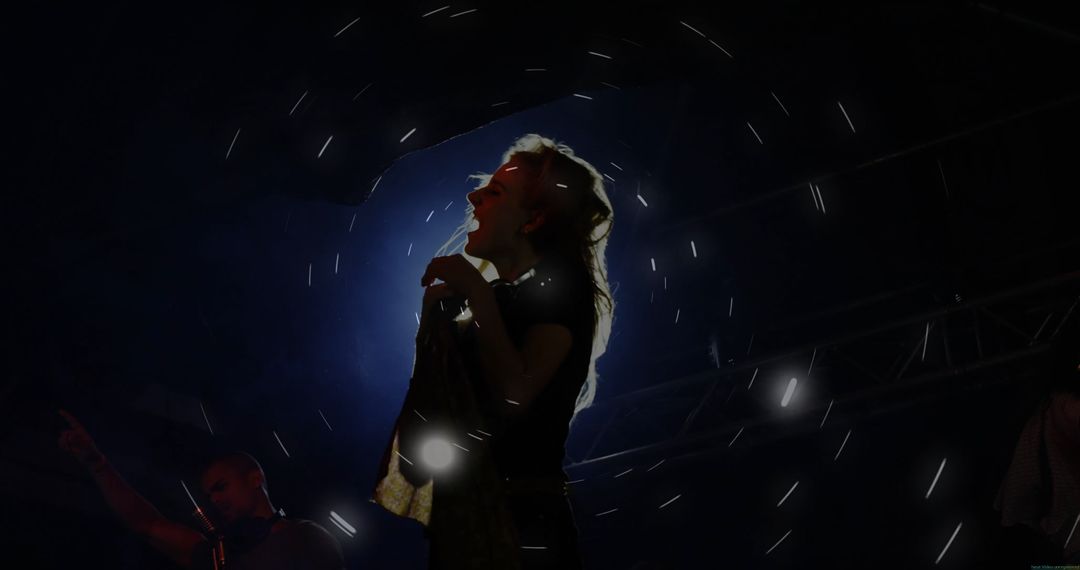 Vibrant Backlit Live Performance of Female Singer on Stage