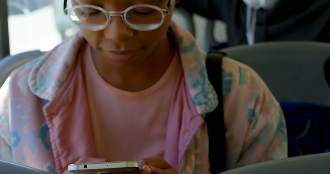 Young Woman Wearing Glasses Using Smartphone on Bus - Free Images, Stock Photos and Pictures on Pikwizard.com