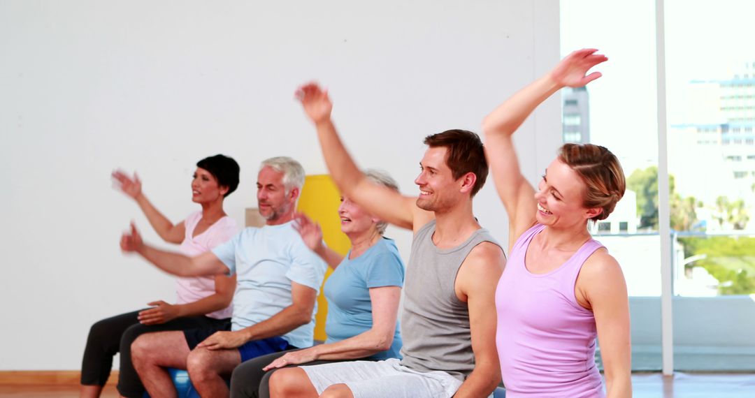 Group of adults practicing seated aerobics indoors - Free Images, Stock Photos and Pictures on Pikwizard.com