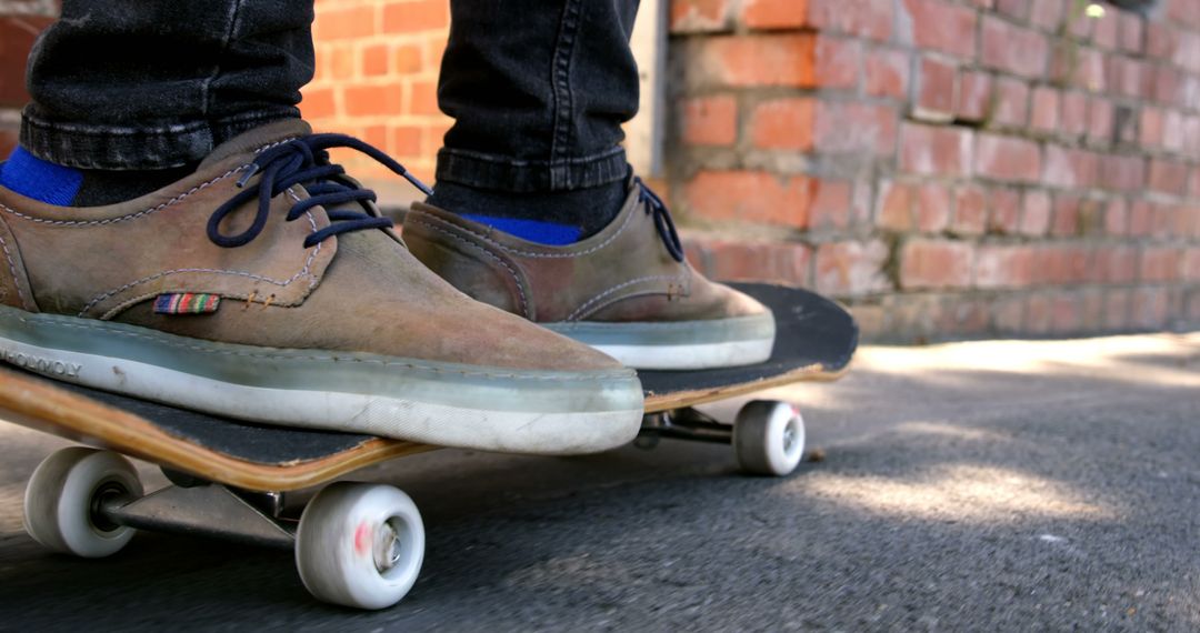 A person wearing casual shoes stands on a skateboard, with copy space - Free Images, Stock Photos and Pictures on Pikwizard.com