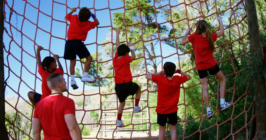 Children Climbing Rope Net During Outdoor Obstacle Course Exercise - Free Images, Stock Photos and Pictures on Pikwizard.com