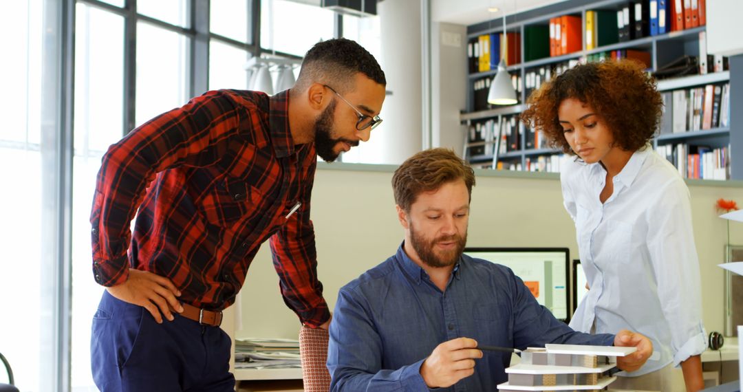 Collaborative Team Discussing Design Project in Modern Office