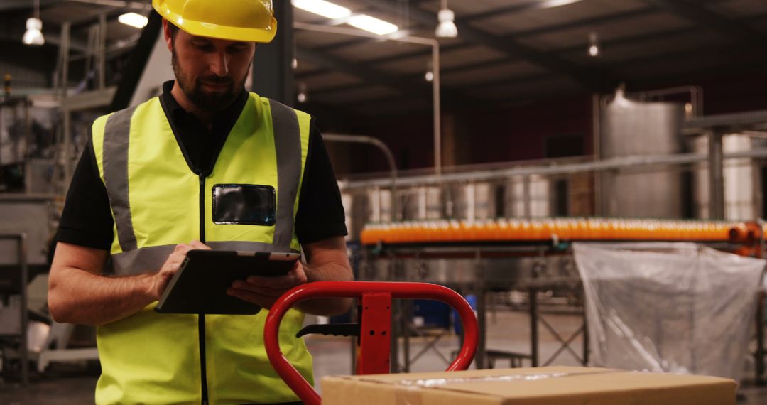 Warehouse Worker Wearing Safety Equipment Checking Inventory on Tablet - Free Images, Stock Photos and Pictures on Pikwizard.com