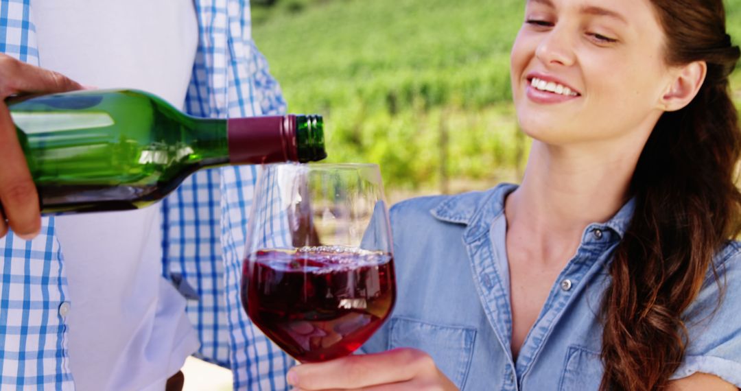 Smiling woman enjoying red wine in vineyard - Free Images, Stock Photos and Pictures on Pikwizard.com