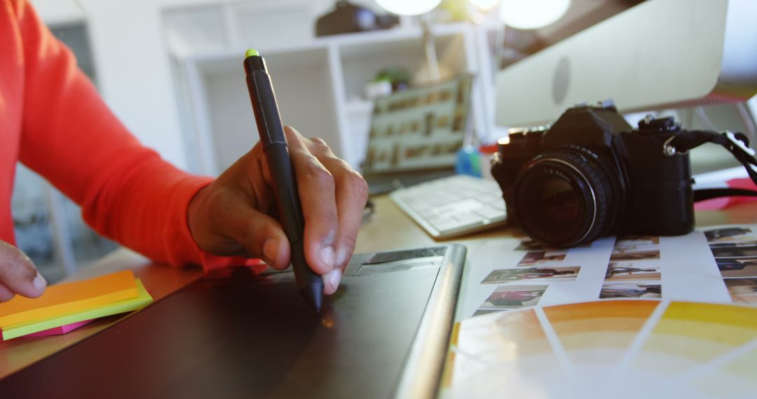 Fashion Designer Working with Graphic Tablet and Photographs