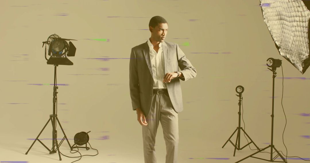 Elegant Male Model Checking Watch in Professional Studio