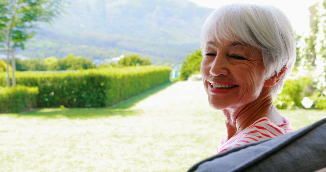 Senior Woman Smiling Outdoors in Garden - Free Images, Stock Photos and Pictures on Pikwizard.com