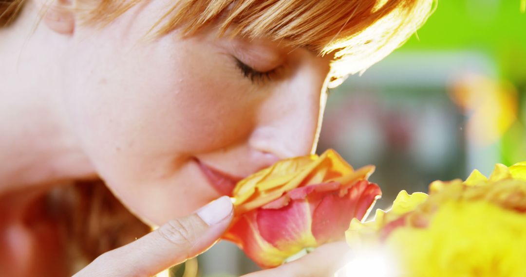 Woman Savoring Fragrance of Vibrant Rose in Sunshine - Free Images, Stock Photos and Pictures on Pikwizard.com